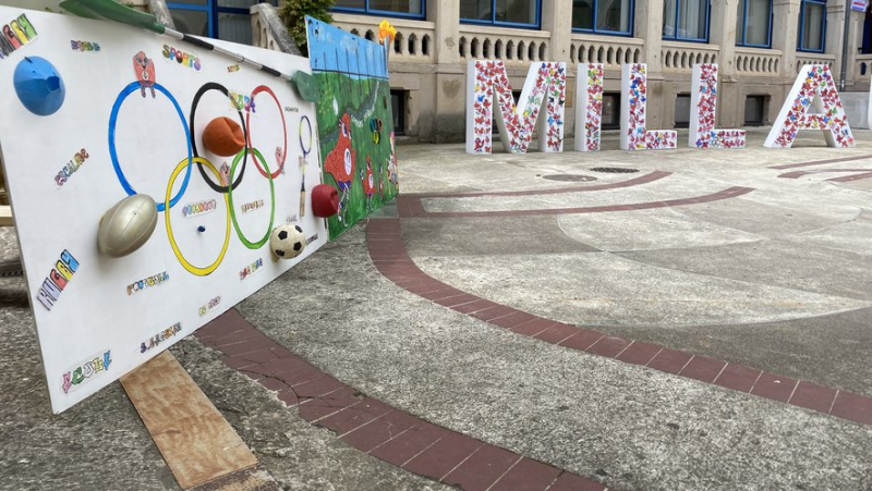 Local students decorate the Crea courtyard in the colors of the Olympics